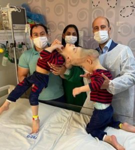 Surgeon Dr. Jeelani with the twins Bernardo and Arthur, and their parents. Picture: Gemini Untwined/PA