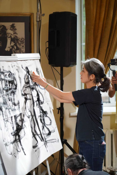 A cross-media live performance with the application of real-time gestural painting for sound manipulation, which consists of a microcomputer, sensing technology, and interactive sound. In the picture: Haruka Hirayama, Hokkaido Information University