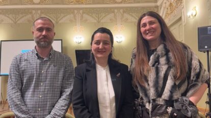 One man and two women in a row