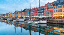 Nyhavn in Copenhagen, Denmark. with colourful facades of old houses and old ships in the Old Town of Copenhagen, capital of Denmark.